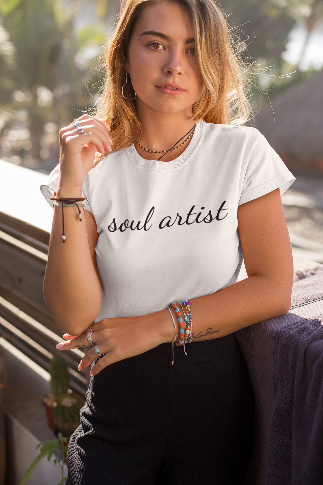 soul artist graphic t shirt black soul artist on white t shirt being worn by young women in tropical setting